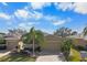 Aerial view of tan villa with two-car garage and paver driveway at 2416 Kensington Greens Dr # 2416, Sun City Center, FL 33573