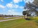 Golf course view with palm trees and a pond at 2416 Kensington Greens Dr # 2416, Sun City Center, FL 33573