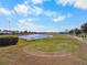 Overhead capture of a well-kept golf course with tee box and pond at 2416 Kensington Greens Dr # 2416, Sun City Center, FL 33573