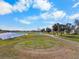 Beautiful golf course with a water hazard and meticulously manicured tee box at 2416 Kensington Greens Dr # 2416, Sun City Center, FL 33573