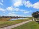 Scenic golf course view featuring a serene pond and lush green surroundings at 2416 Kensington Greens Dr # 2416, Sun City Center, FL 33573