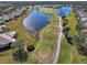 Aerial view of a sprawling golf course featuring multiple tee boxes and a scenic lake at 2416 Kensington Greens Dr # 2416, Sun City Center, FL 33573