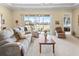 Bright living room with comfy seating, large windows, and golf course views at 2416 Kensington Greens Dr # 2416, Sun City Center, FL 33573