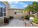 Brick paved patio with wicker furniture and tropical plants at 2416 Kensington Greens Dr # 2416, Sun City Center, FL 33573