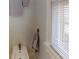 Small bathroom with pedestal sink, and a window with mini blinds at 2418 2Nd S Ave, St Petersburg, FL 33712