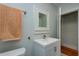 Bathroom with updated vanity, toilet, and a vintage medicine cabinet at 2418 2Nd S Ave, St Petersburg, FL 33712