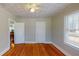 Bedroom with hardwood floors, ceiling fan and access to other rooms at 2418 2Nd S Ave, St Petersburg, FL 33712