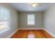 Simple bedroom with hardwood floors and two windows at 2418 2Nd S Ave, St Petersburg, FL 33712