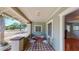 Inviting front porch with tiled floor and wrought iron chairs, offering a relaxing outdoor space at 2418 2Nd S Ave, St Petersburg, FL 33712