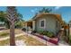 Side view of a charming green house and walkway at 2418 2Nd S Ave, St Petersburg, FL 33712