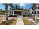 Front view of a charming green house with porch at 2418 2Nd S Ave, St Petersburg, FL 33712