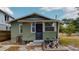 Green house exterior with small front yard and bicycles at 2418 2Nd S Ave, St Petersburg, FL 33712