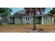 Rear view of a green house with a large backyard at 2418 2Nd S Ave, St Petersburg, FL 33712