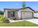 Newly constructed one-story home with a two-car garage and landscaped front yard at 29470 Fedora Cir, Brooksville, FL 34602