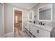 Modern bathroom with double vanity, granite countertop and large mirrors at 2973 Somersworth Dr, Clearwater, FL 33761