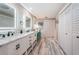 Elegant bathroom with double vanity, marble counters, and stylish light fixtures at 2973 Somersworth Dr, Clearwater, FL 33761