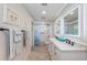 Clean bathroom with double vanity, a shower/tub combo, and updated fixtures at 2973 Somersworth Dr, Clearwater, FL 33761