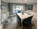 Bright dining room with white table and blue chairs, hardwood floors at 2973 Somersworth Dr, Clearwater, FL 33761