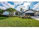 Beautiful mid-century modern home with landscaped lawn and updated facade at 2973 Somersworth Dr, Clearwater, FL 33761