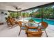 Relaxing screened-in patio with wicker furniture and a sparkling pool at 2973 Somersworth Dr, Clearwater, FL 33761