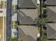 Aerial view of houses features roof lines and manicured landscaping at 31806 Larkenheath Dr, Wesley Chapel, FL 33543