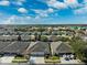 Wide aerial view of houses shows roof lines and manicured lawns at 31806 Larkenheath Dr, Wesley Chapel, FL 33543