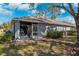 Home exterior shows a screened in porch, privacy landscaping and mature trees at 31806 Larkenheath Dr, Wesley Chapel, FL 33543