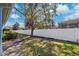 Backyard shows a manicured lawn and a white vinyl privacy fence at 31806 Larkenheath Dr, Wesley Chapel, FL 33543