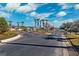 Gated community entrance with palm trees, lush greenery, and an access control system for enhanced security at 31806 Larkenheath Dr, Wesley Chapel, FL 33543