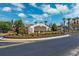 Well-manicured entrance sign for Larkenheath, with lush landscaping and clear signage under a bright, partly cloudy sky at 31806 Larkenheath Dr, Wesley Chapel, FL 33543