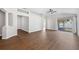 Spacious living room featuring wood flooring, modern ceiling fan, and natural light at 31806 Larkenheath Dr, Wesley Chapel, FL 33543