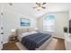 This main bedroom features a ceiling fan, recessed lighting, and a large arched window for plenty of natural light at 31806 Larkenheath Dr, Wesley Chapel, FL 33543