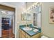 Clean bathroom with teal countertops and a view of the home office at 3710 Rain Tree Ct, Palm Harbor, FL 34685