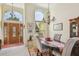 Elegant dining room with soaring ceiling, wood table, four chairs, and a decorative chandelier at 3710 Rain Tree Ct, Palm Harbor, FL 34685