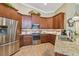 Spacious kitchen with stainless steel appliances and granite countertops at 3710 Rain Tree Ct, Palm Harbor, FL 34685