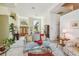 Bright living room with hardwood floors, a light-colored sofa and large windows at 3710 Rain Tree Ct, Palm Harbor, FL 34685