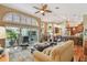 Open-concept living room featuring high ceilings, modern furnishings, and access to the pool area at 3710 Rain Tree Ct, Palm Harbor, FL 34685