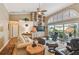 Living room with hardwood floors, vaulted ceilings, and a cozy seating area at 3710 Rain Tree Ct, Palm Harbor, FL 34685