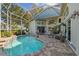 Enclosed pool and patio area with seating and dining furniture at 3710 Rain Tree Ct, Palm Harbor, FL 34685