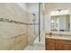 Large walk-in shower with grab bars and tiled walls at 3710 Rain Tree Ct, Palm Harbor, FL 34685