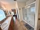 Bright bathroom features a glass shower enclosure, and sinks and tile flooring at 37544 Corey Lewis Ave, Zephyrhills, FL 33541