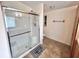 Bright bathroom features a glass shower enclosure and tile flooring for easy maintenance at 37544 Corey Lewis Ave, Zephyrhills, FL 33541