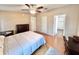 Comfortable bedroom with hardwood floors, ceiling fan and ample closet space at 37544 Corey Lewis Ave, Zephyrhills, FL 33541