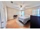 A bright bedroom featuring a ceiling fan and wood flooring at 37544 Corey Lewis Ave, Zephyrhills, FL 33541