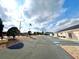 Community building with parking lot and flagpole at 37544 Corey Lewis Ave, Zephyrhills, FL 33541