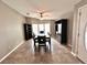 Inviting dining room with a ceiling fan, dark wood furniture, and natural light from windows at 37544 Corey Lewis Ave, Zephyrhills, FL 33541