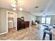 Open dining room area with tile floors, a chandelier, and views into the living room at 37544 Corey Lewis Ave, Zephyrhills, FL 33541