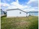 Mobile home back view, showcasing a spacious yard at 37544 Corey Lewis Ave, Zephyrhills, FL 33541