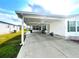 Home exterior with car port, landscaping and clean siding at 37544 Corey Lewis Ave, Zephyrhills, FL 33541