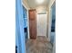 Hallway featuring hard surface floors, wood cabinets, and access to bedrooms and bathroom at 37544 Corey Lewis Ave, Zephyrhills, FL 33541